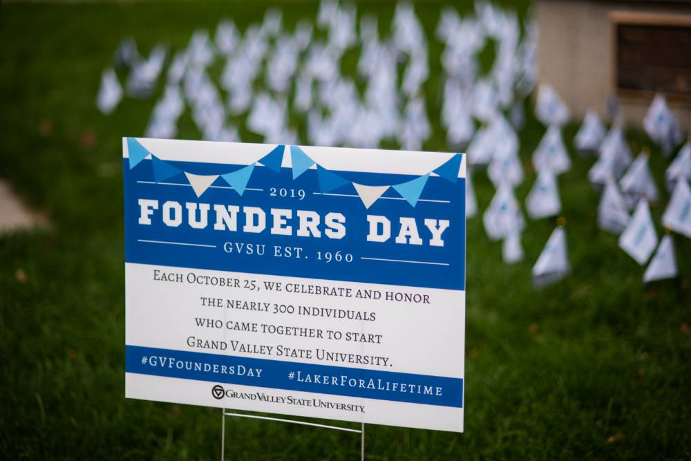 Founders Day sign in front of Founders Day flags